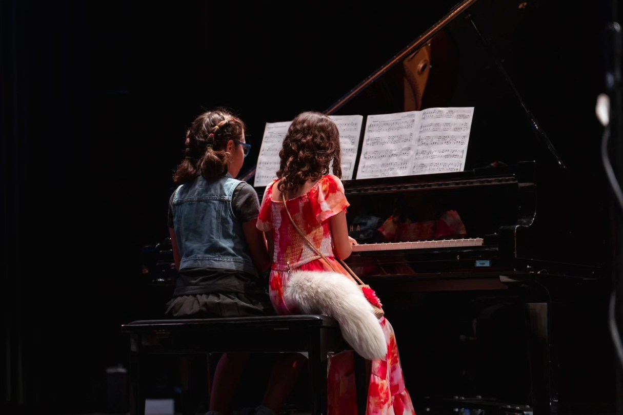 Group of adults performing contemporary dance moves on stage, showcasing expressive movement and teamwork| Learn The Art